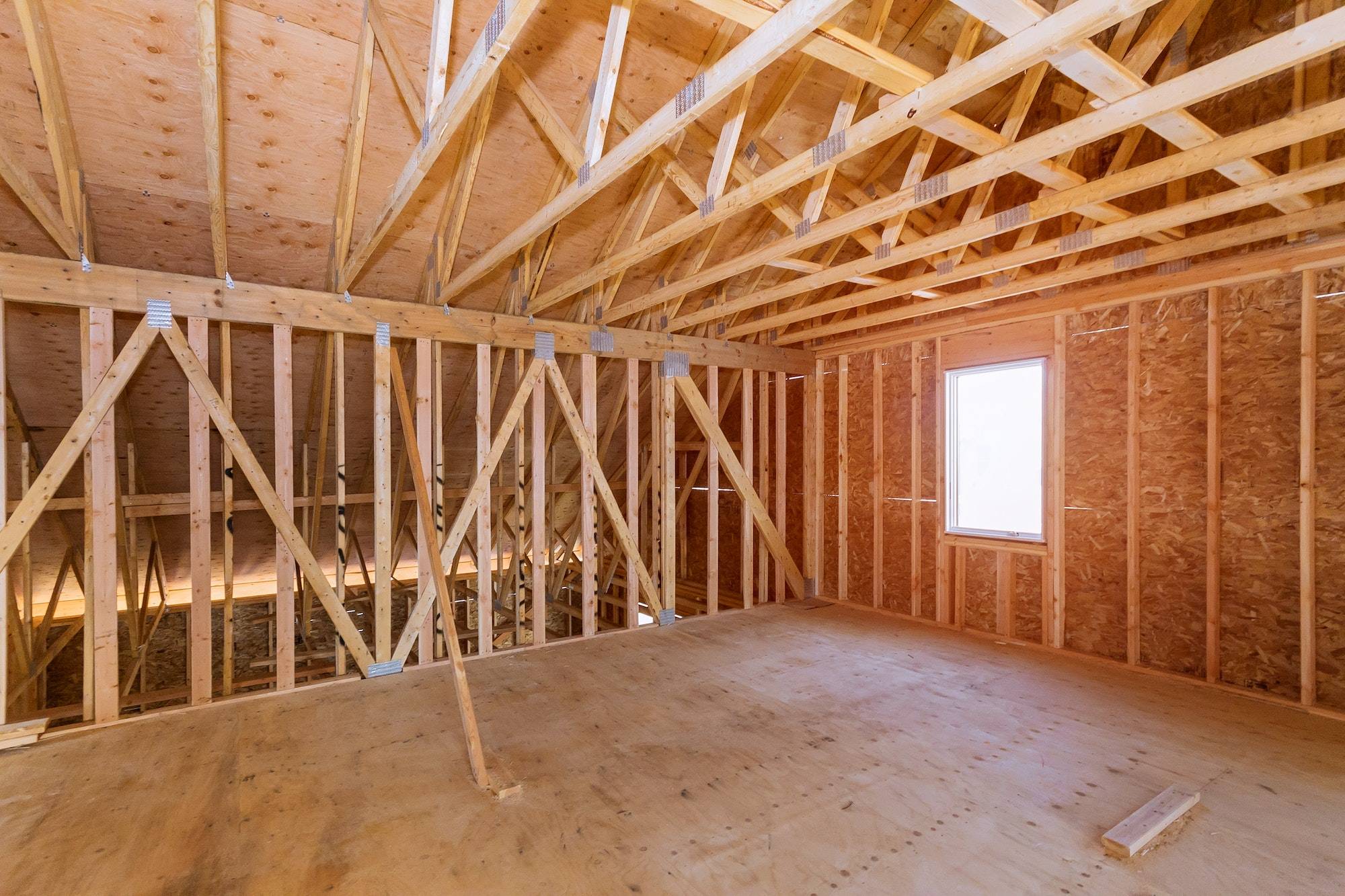 Unfinished attic of a private house residential construction house framing agains